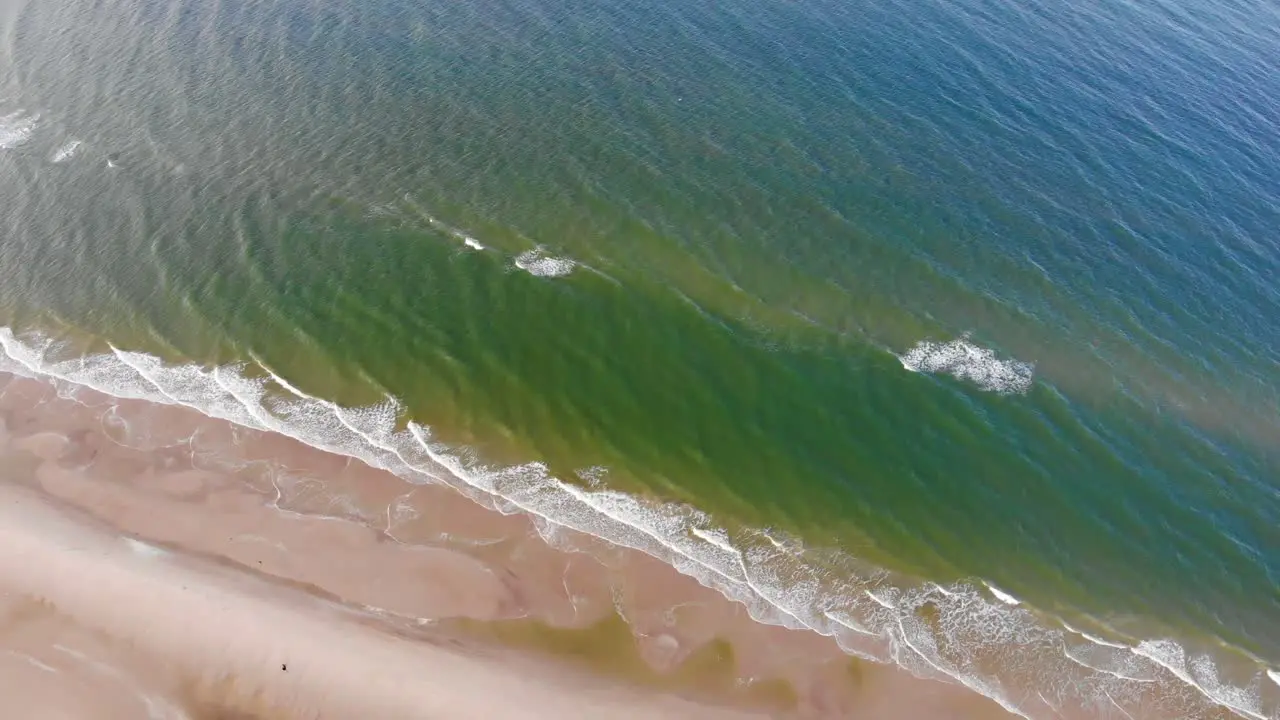 Aerial view of the North Sea shoreline with rolling waves outside Løkken Denmark