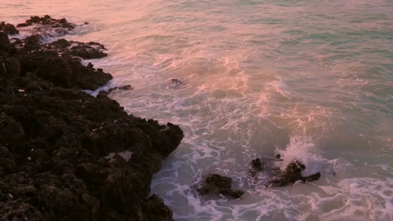 Slow motion Waves splashing into rock