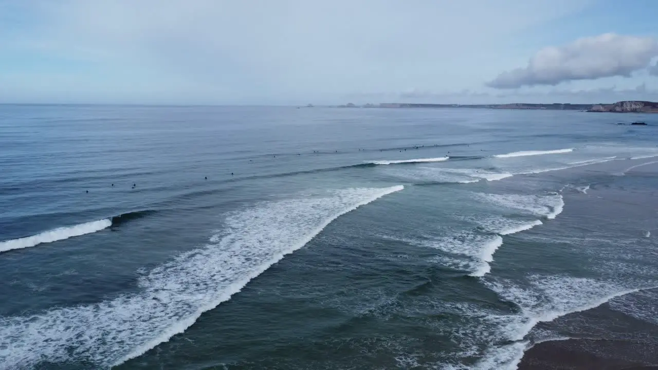 Drone circles above the line up in La Palue bay in Brittany in France many surfers in the waves