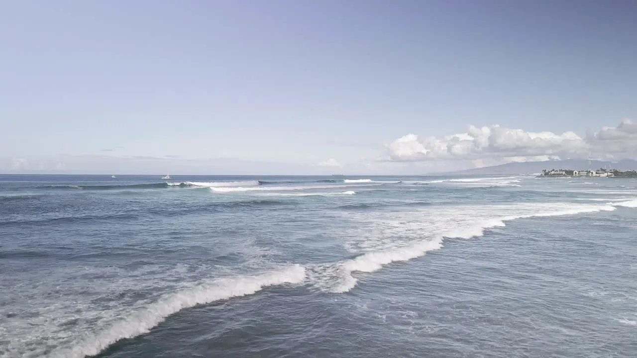 Panoramic view of waves off of Magic island in Hawaii rising