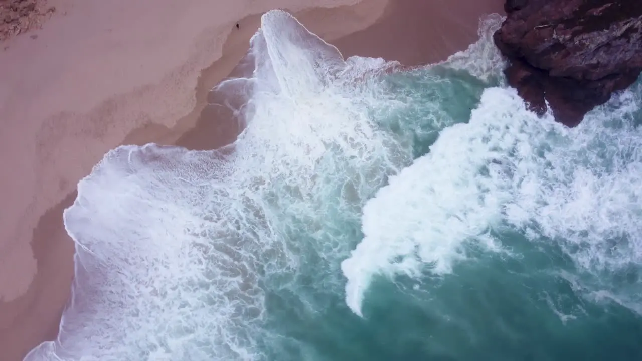 AERIAL Fast Top Down Rotating Shot of Wild Waves at Praia da Ursa Portugal