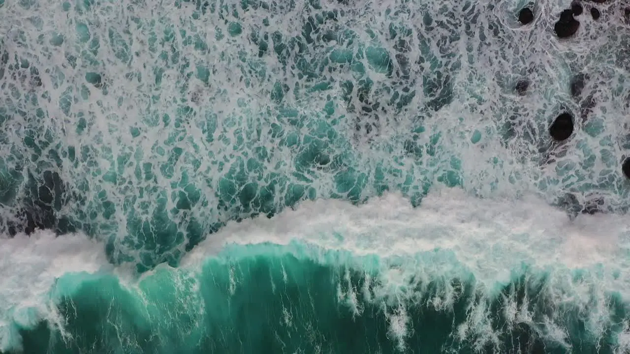 Aerial shot of big turquoise ocean waves crashing coastline of Nusa penida island one of the tourist attractions of Bali island Crystal beach kelingking beach angle billabong broken beach