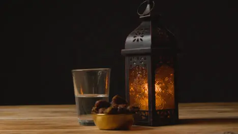 Tracking Shot of Dates Water and a Lantern On Table