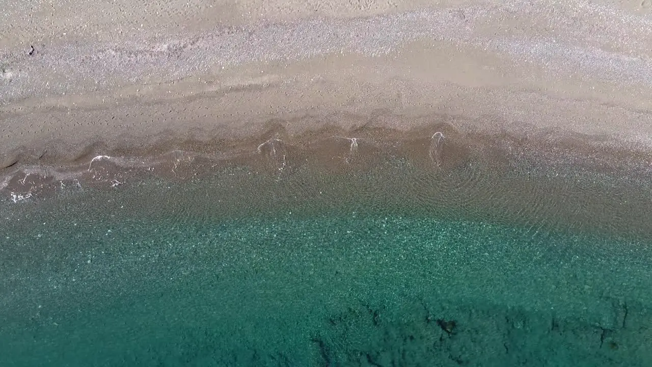 Rising aerial looking down on a beautiful tropical beach