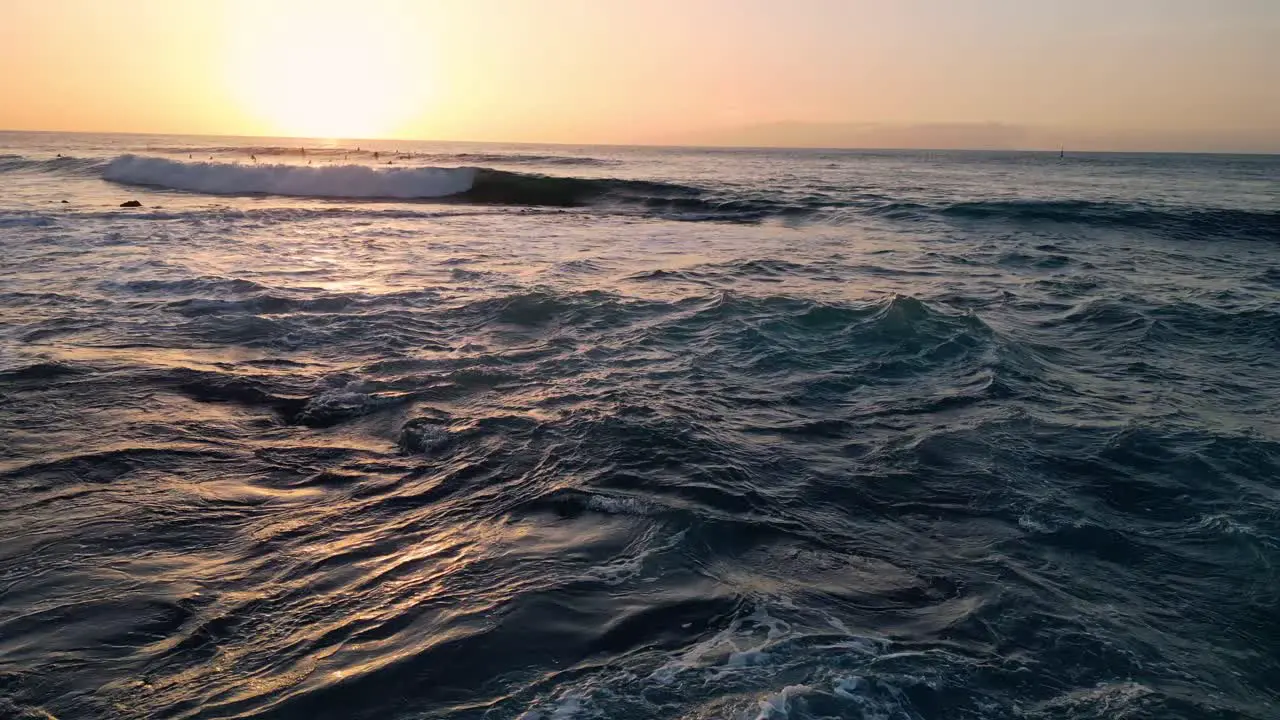 Aerial view of the ocean surface at sunset