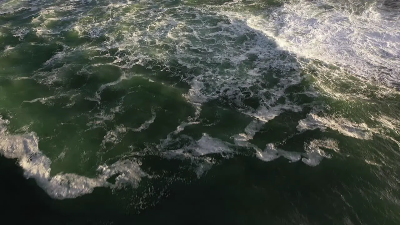 Cinematic Tilt-Up Shot of Rough Ocean With Big Waves and Rocks