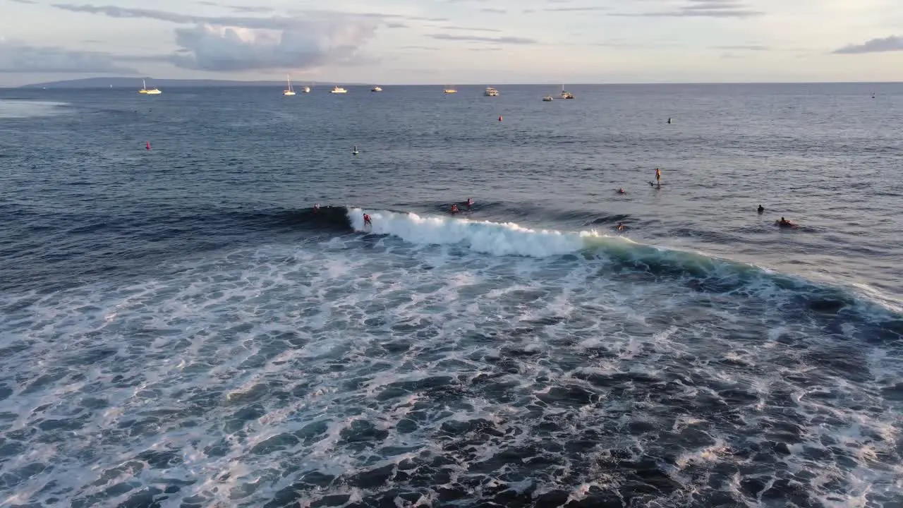 Drone shot of surfer riding an amazing wave in Hawaii