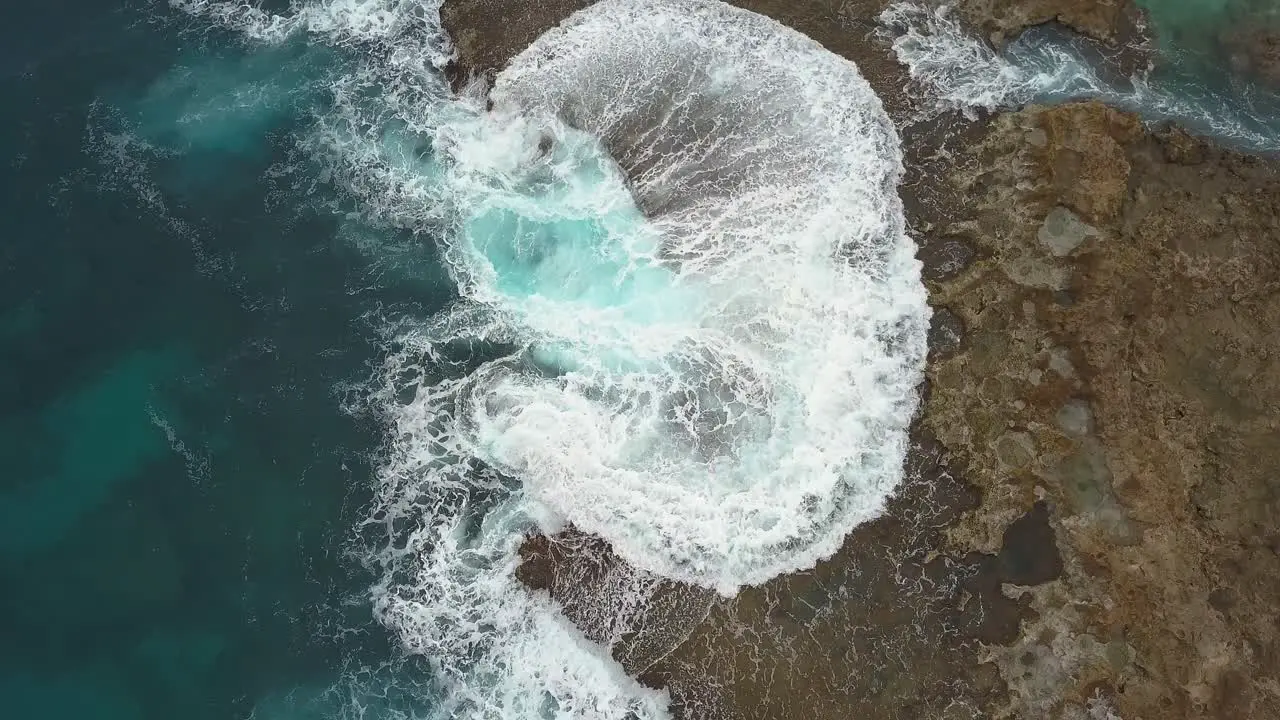 Overhead view of waves crashing onto rocky shore at Sharks cove Hawaii