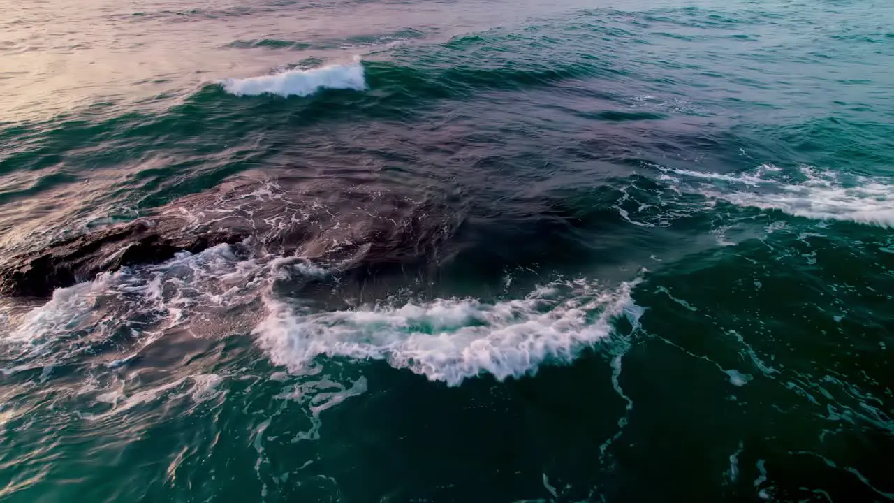 Ocean waves moving backwards and tilting up into the horizon