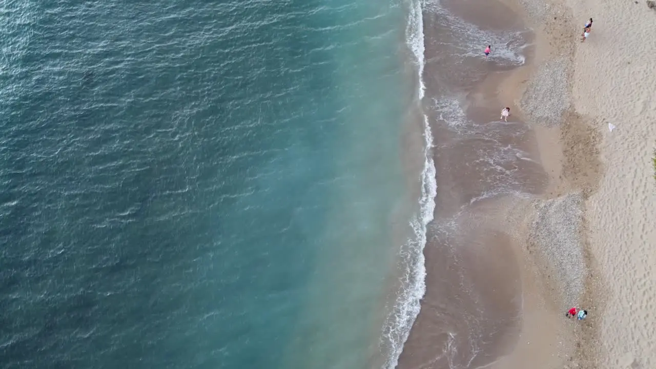 Steady shot of blue waves crashing into beach in Hawaii