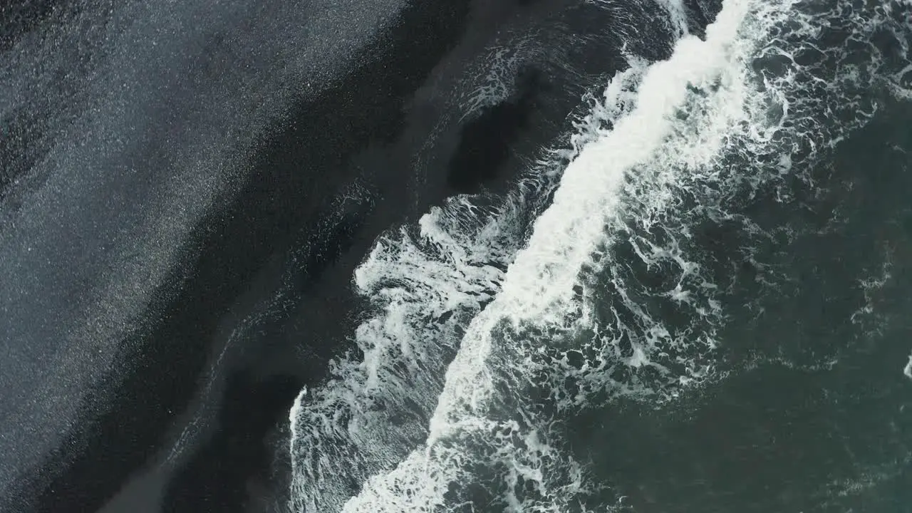 Rising from mythical dark sand beach on Iceland south shore aerial