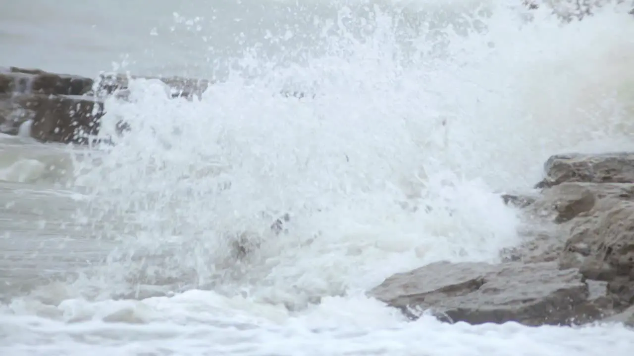 Big Waves Of Water Almost Covering The Pile Of Sea Stacks During The Day