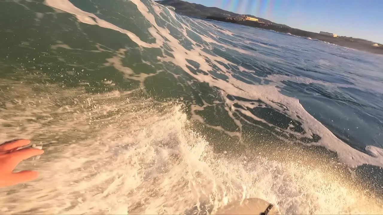 Young man doing a tube and strong reentrie on the end at Guincho surf spot in Cascais