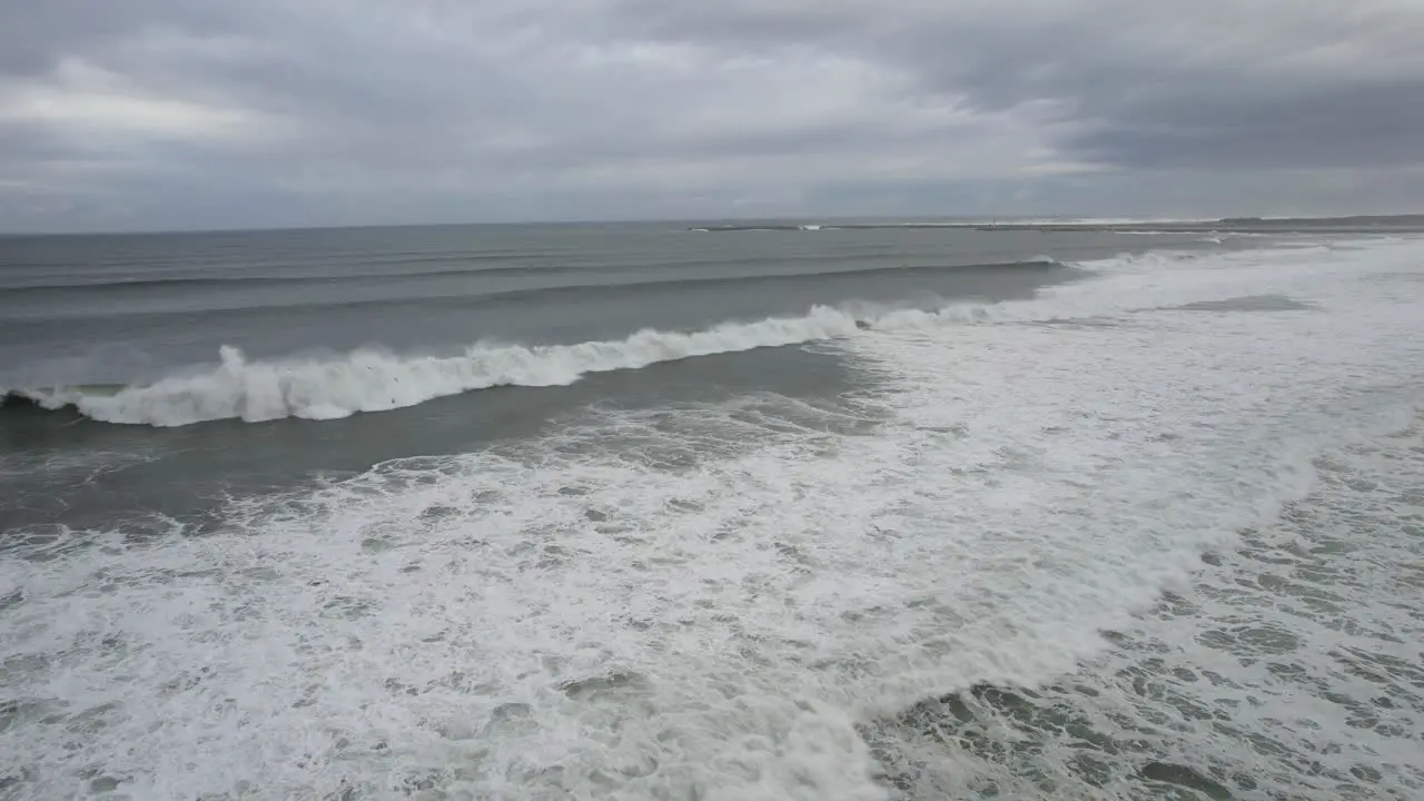 Relaxing slow motion view of waves breaking before reaching the edge of the beach