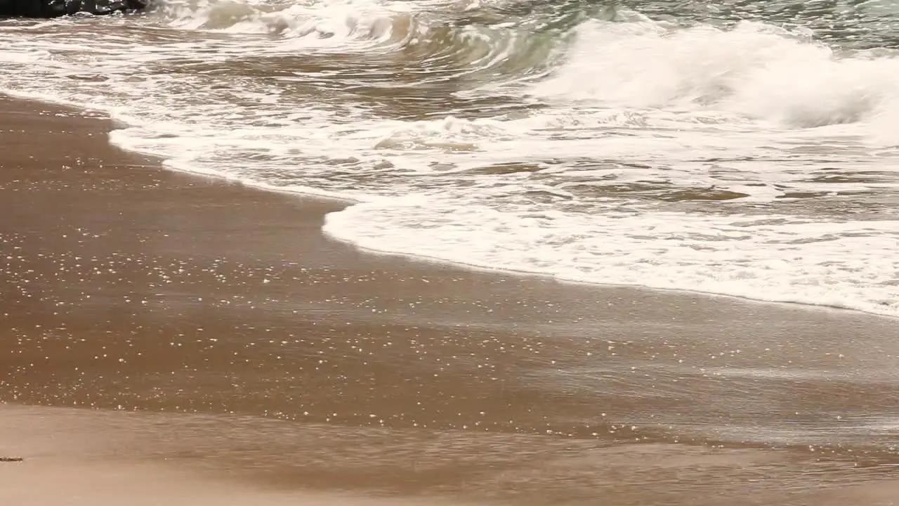 Waves lapping on shallow beach shoreline