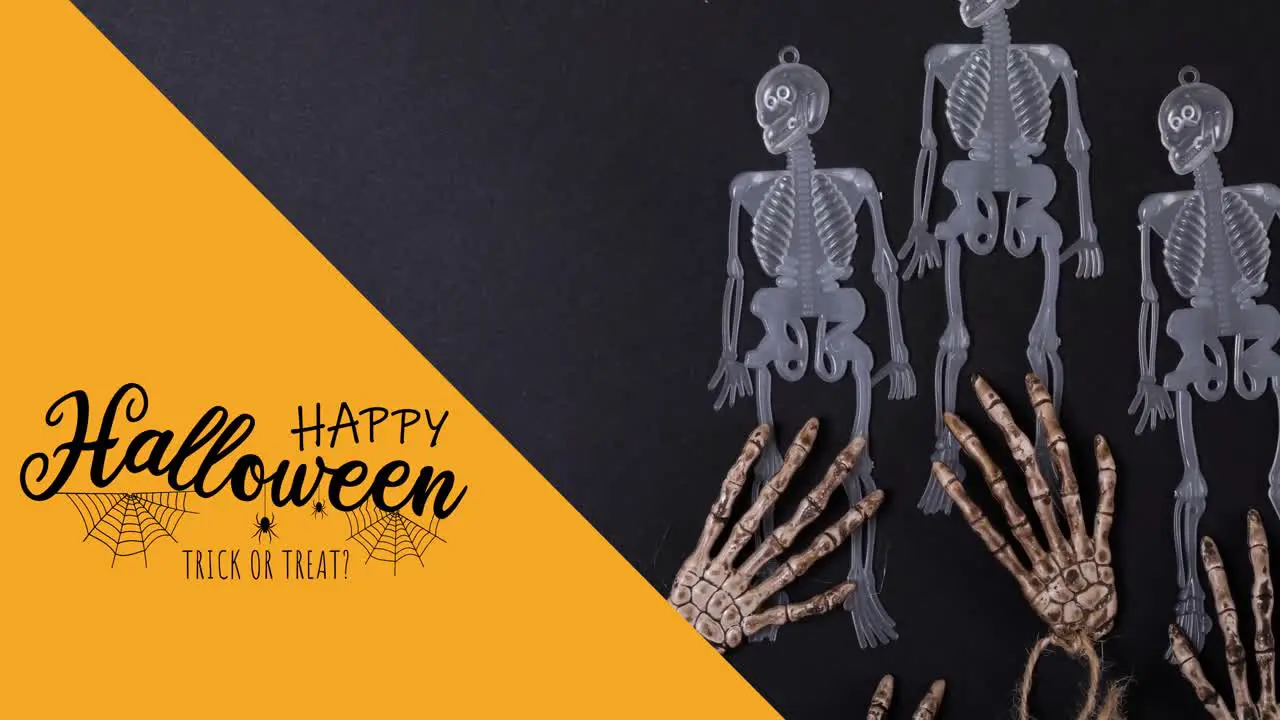 Animation of happy halloween text over skeletons