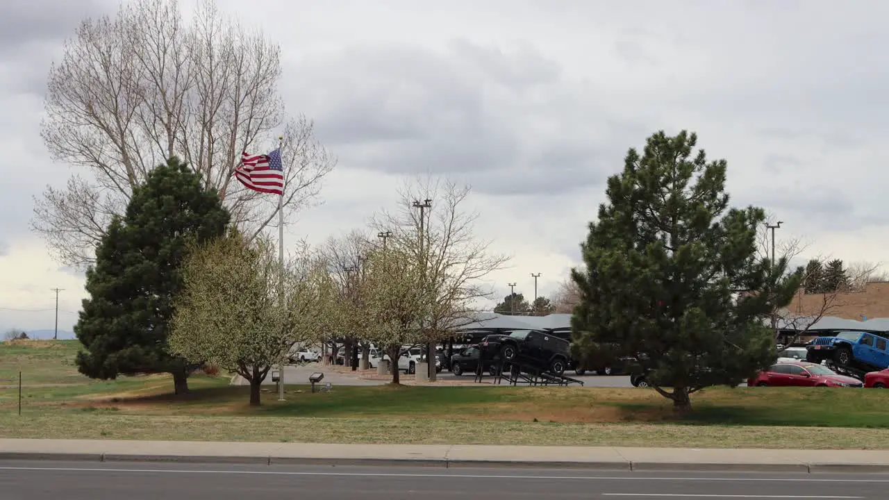 Extreme wind in Northern Colorado American flag with trees and traffic