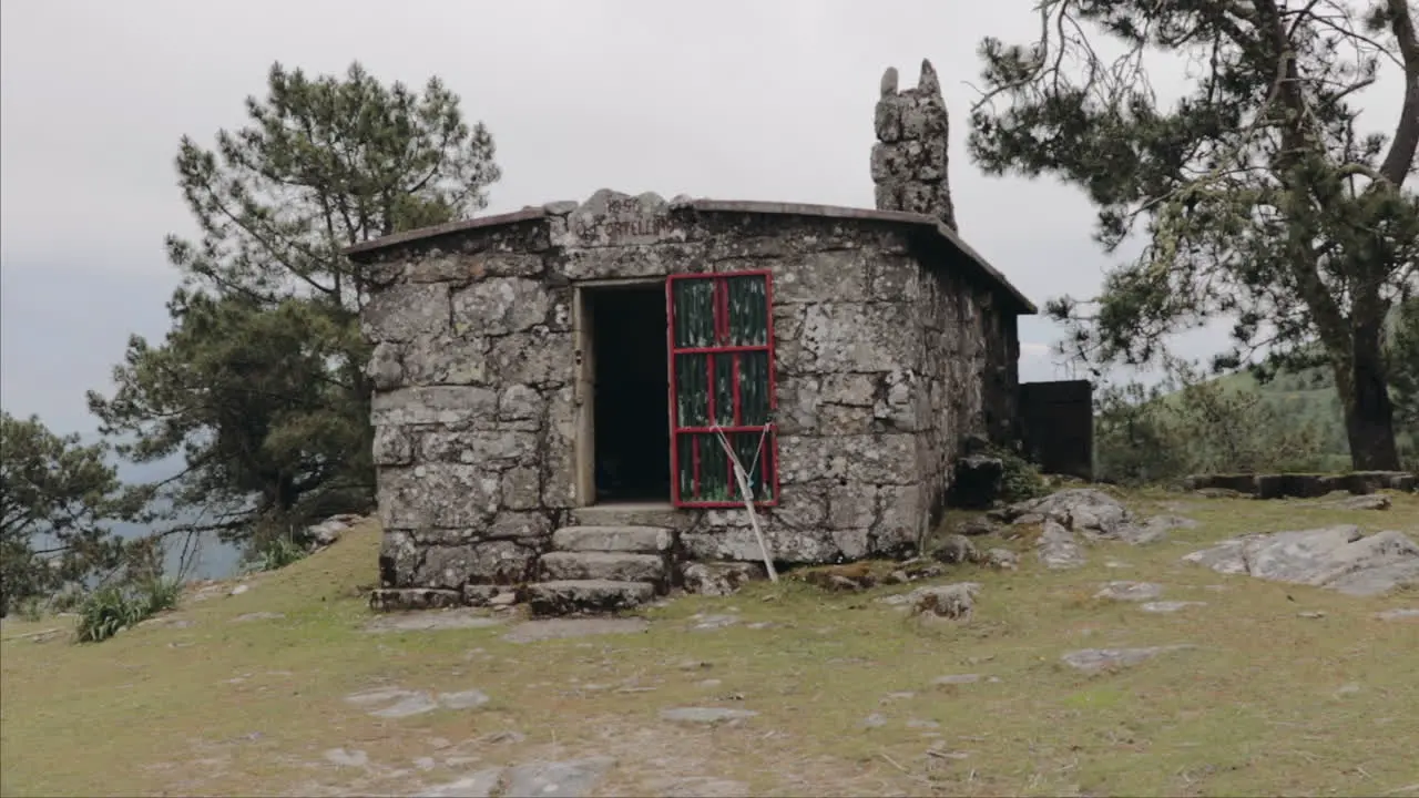 Approaching abandonded cabin in the mountains from point of view