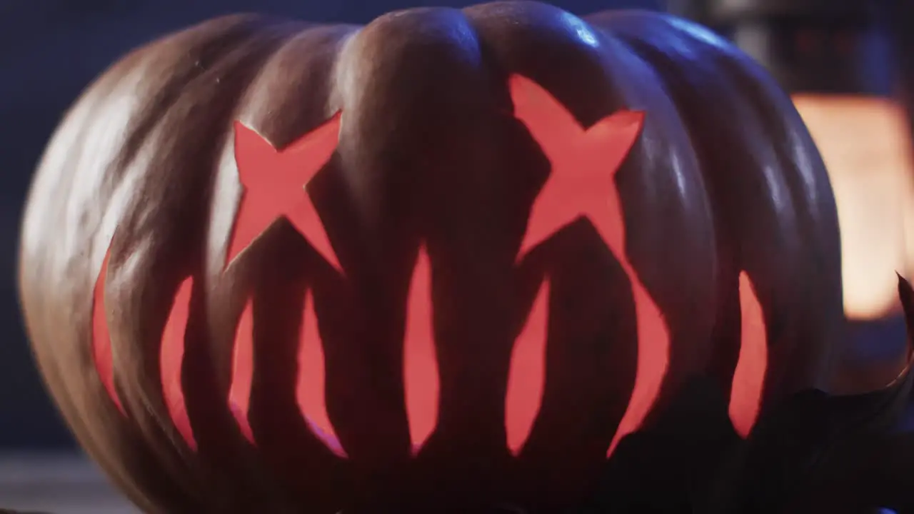 Video of halloween carved pumpkin with copy space on dark background