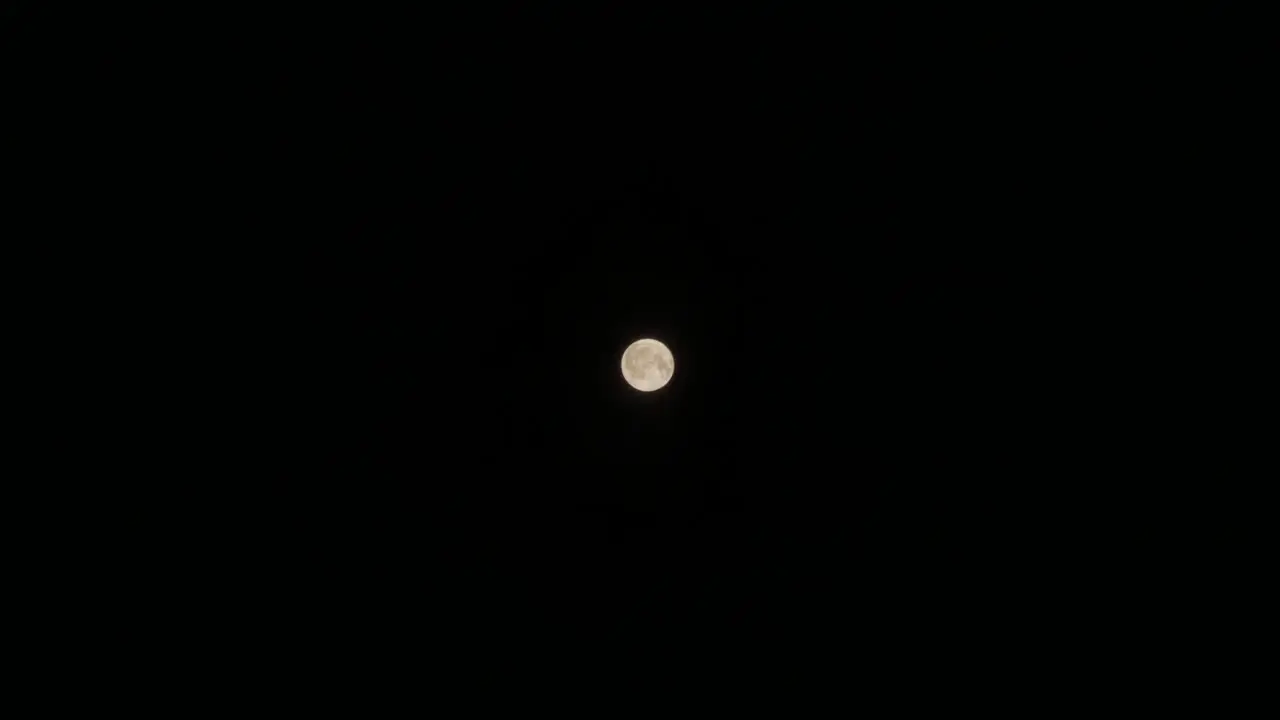 Wide Shot of a Full Moon with Passing Cloud