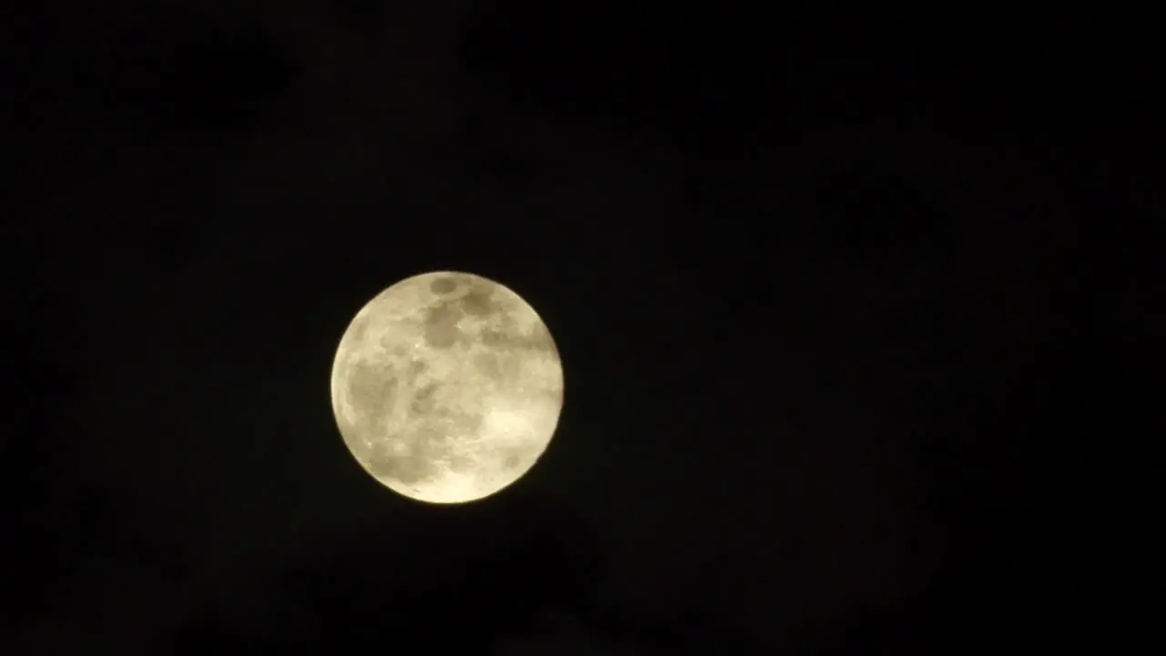 Timelapse of how the full moon rises from behind the clouds