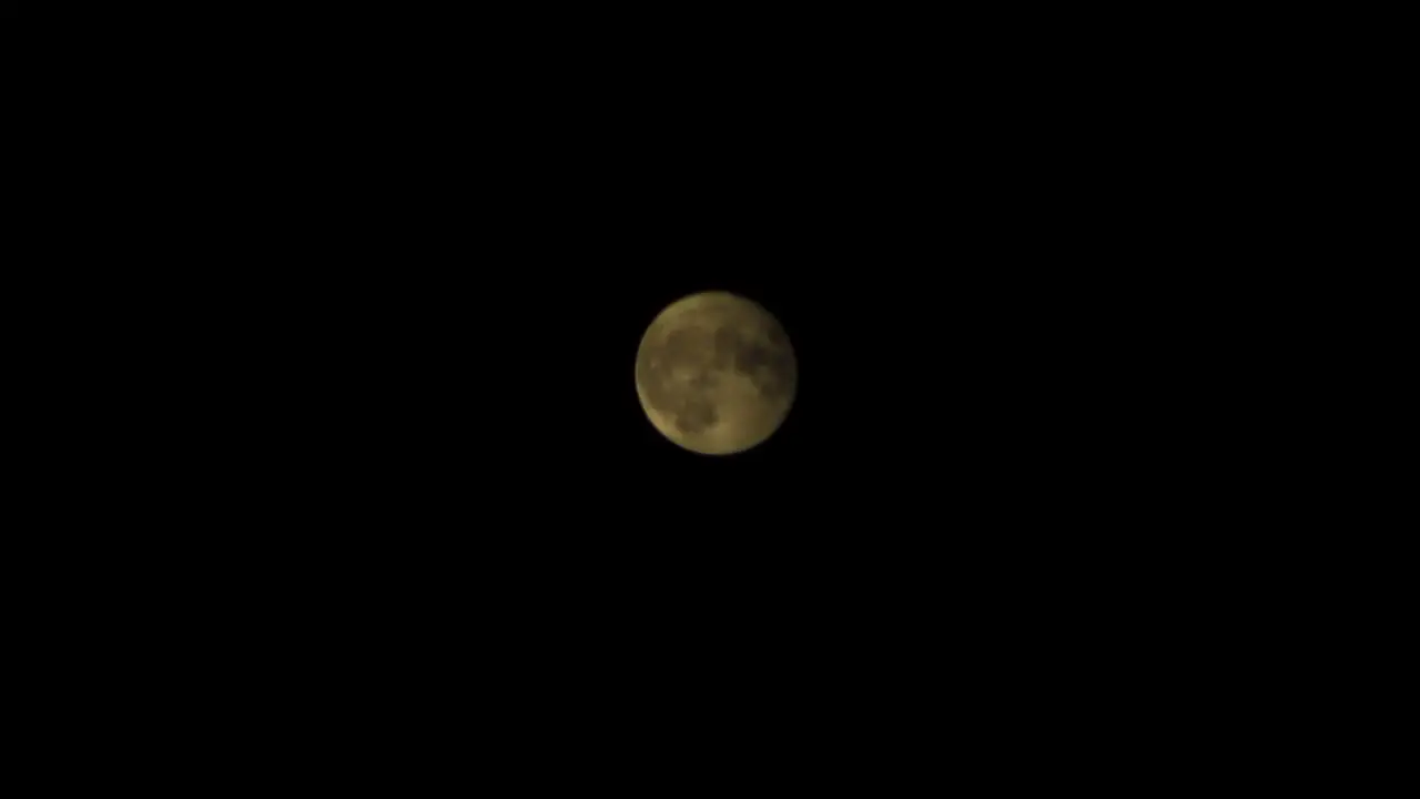 Moon Appears Full Behind Dark Clouds At Night Time Lapse