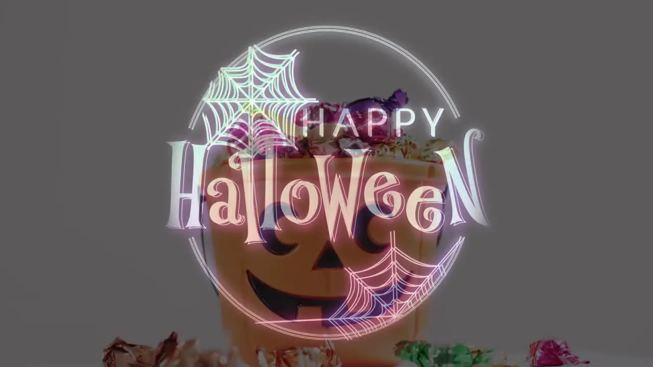 Halloween text banner with spider web icon against pumpkin shaped bucket full of halloween candies