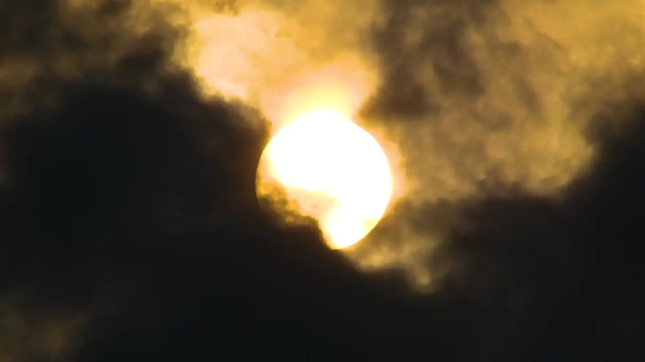 Glowing full moon behind fast moving dark clouds concept scary night