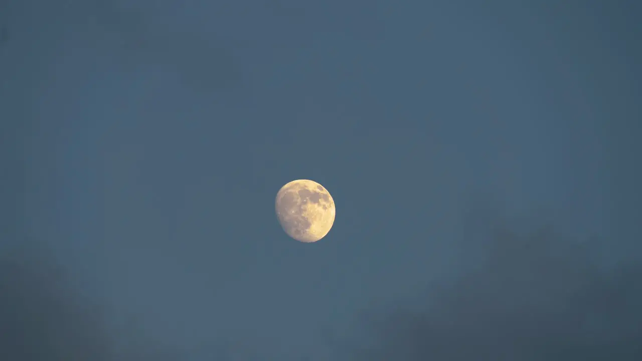 Clouds Slowly Passing by Big Moon in the Sky