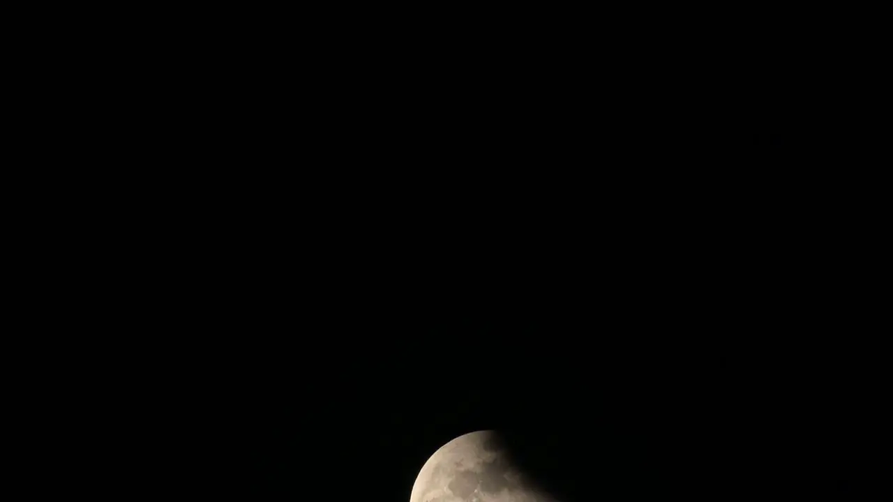 Rising from the bottom going out at the top of the frame while a part of it is covered with shadow as part of the Lunar Eclipse in Thailand last November 8 2022