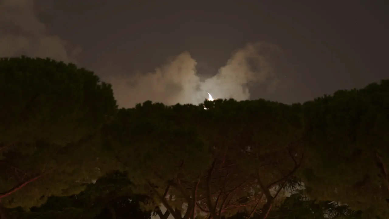 Timelapse of Crescent Moon Setting Behind Trees