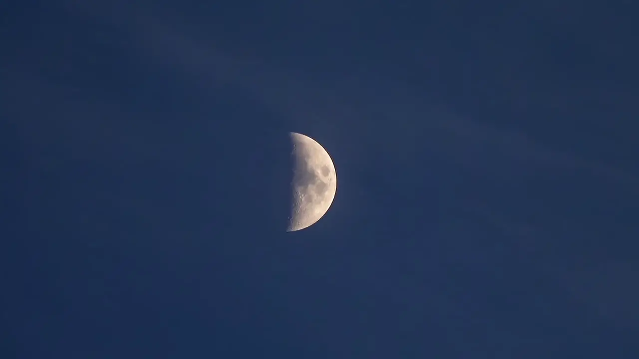 Half moon time lapse in dark night sky -- 4K