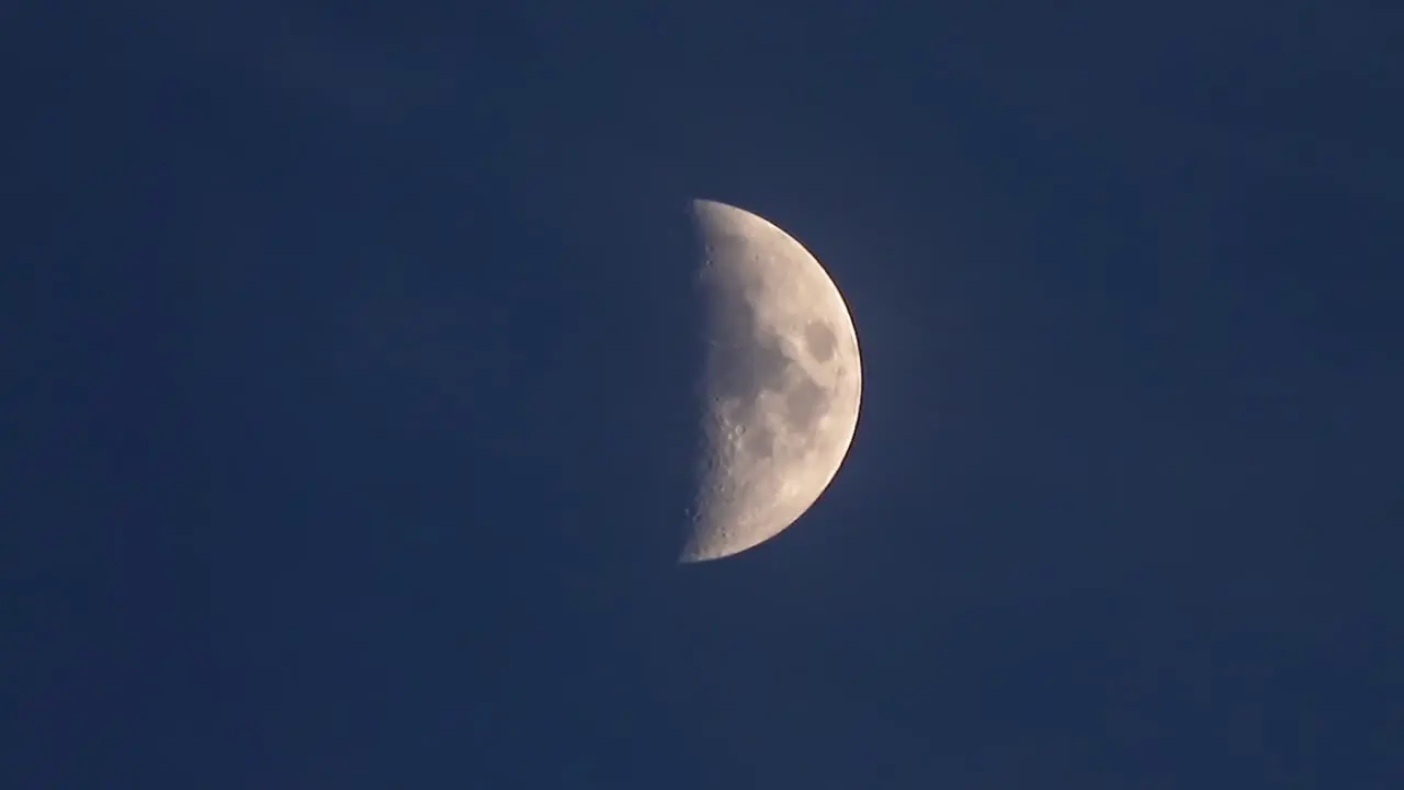 First quarter moon time lapse in night sky -- 4K