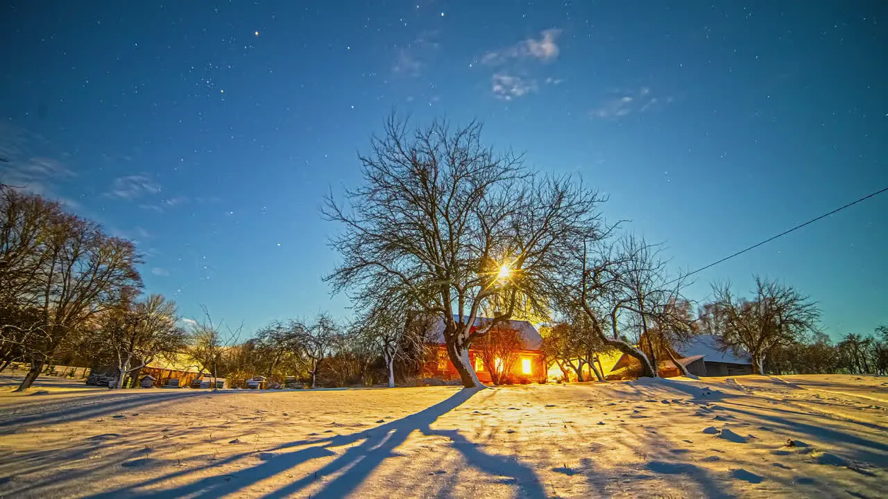 Moon and stars so bright as to cast shadows on the snowy landscape time lapse