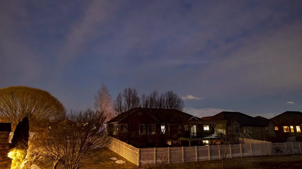 Twilight to moonrise over a suburban neighborhood sliding panning motion time lapse