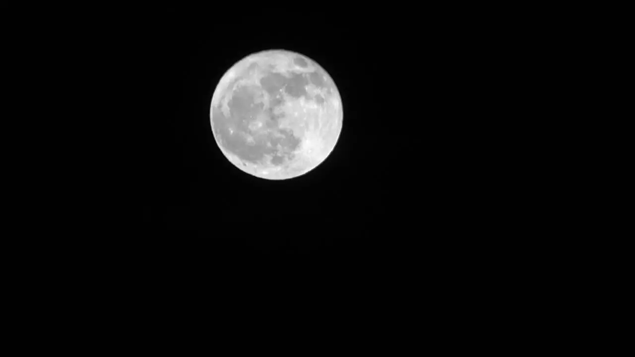 Bright full moon crosses night sky time lapse -- 4K