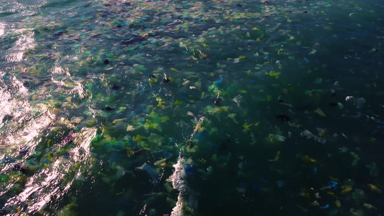 Colour plastic disposable bags float on ocean surface marine pollution concept