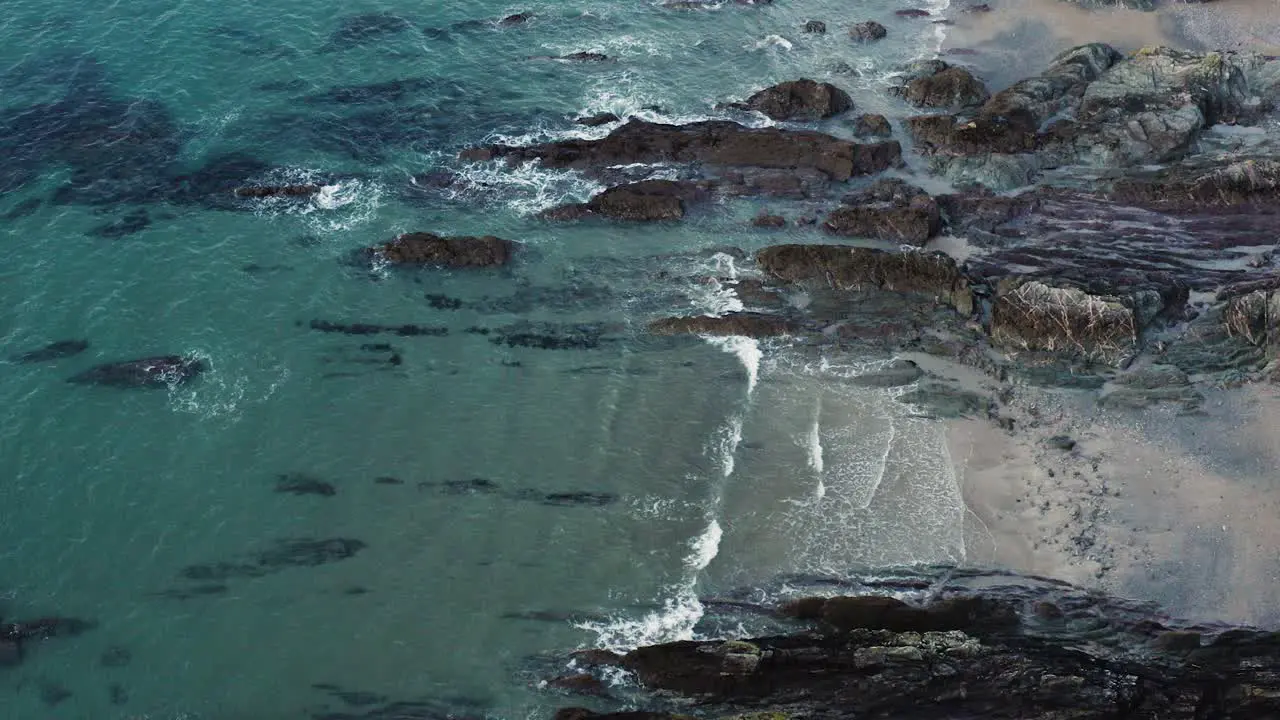 Rolling Calm Waves Over Rocks At Polhawn Fort In Torpoint Cornwall England