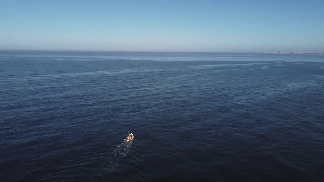 Fishing motorboat leaves wake trail on sea water surface