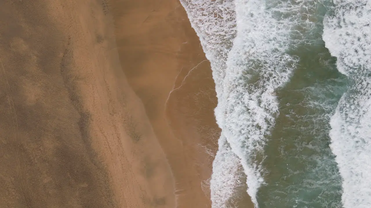 Fantastic aerial aerial shot of the shore of Cofete beach and with the waves breaking on the shore