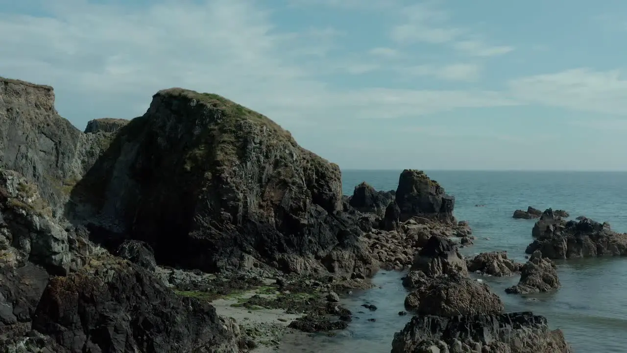 Still aerial shot of cliffs and rocks at ocean during afternoon