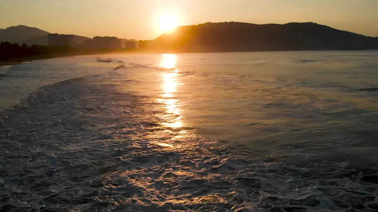 Sunset on the beach with birds and seen from a drone