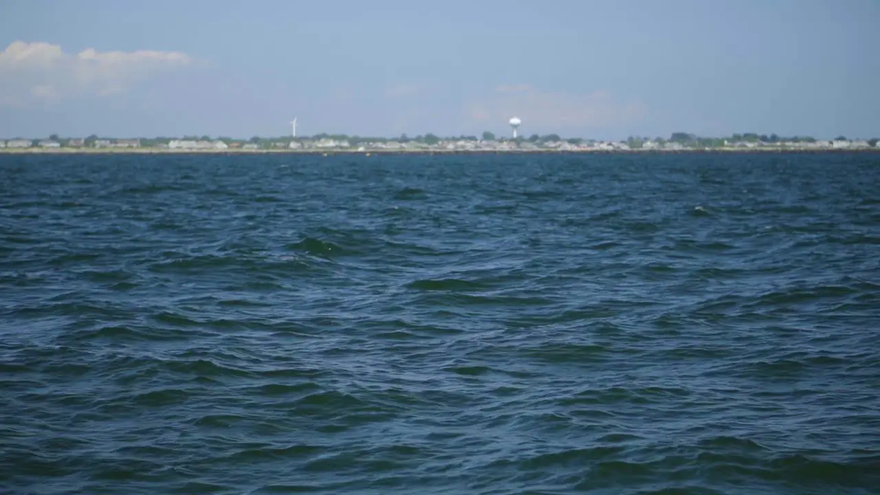 Rolling ocean waves from a boat near the coast in the summertime