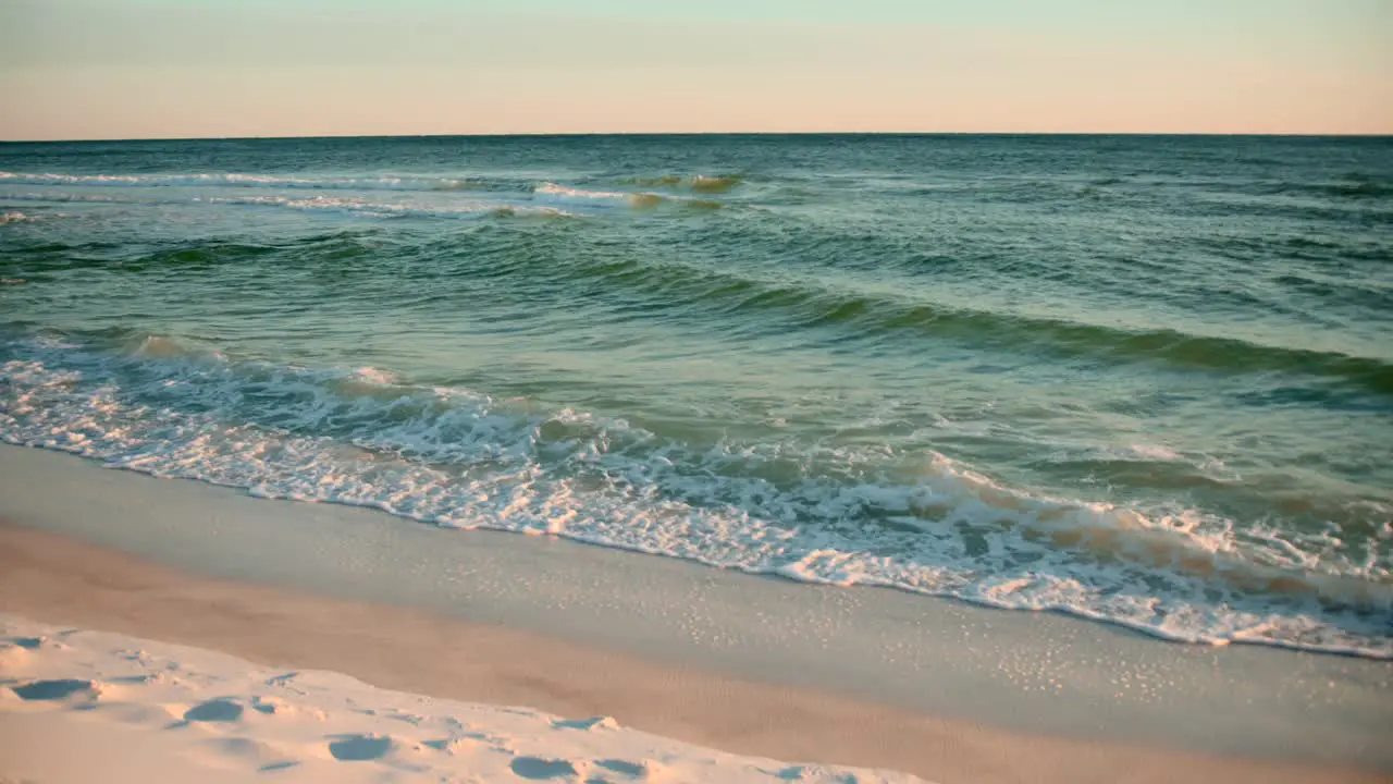 Shots of the ocean on a warm sunny evening with footprints in the sand-2