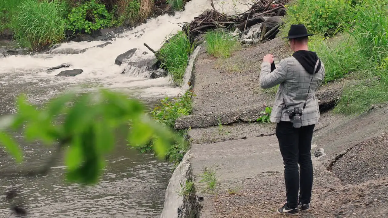 A tourist taking a shot by the river