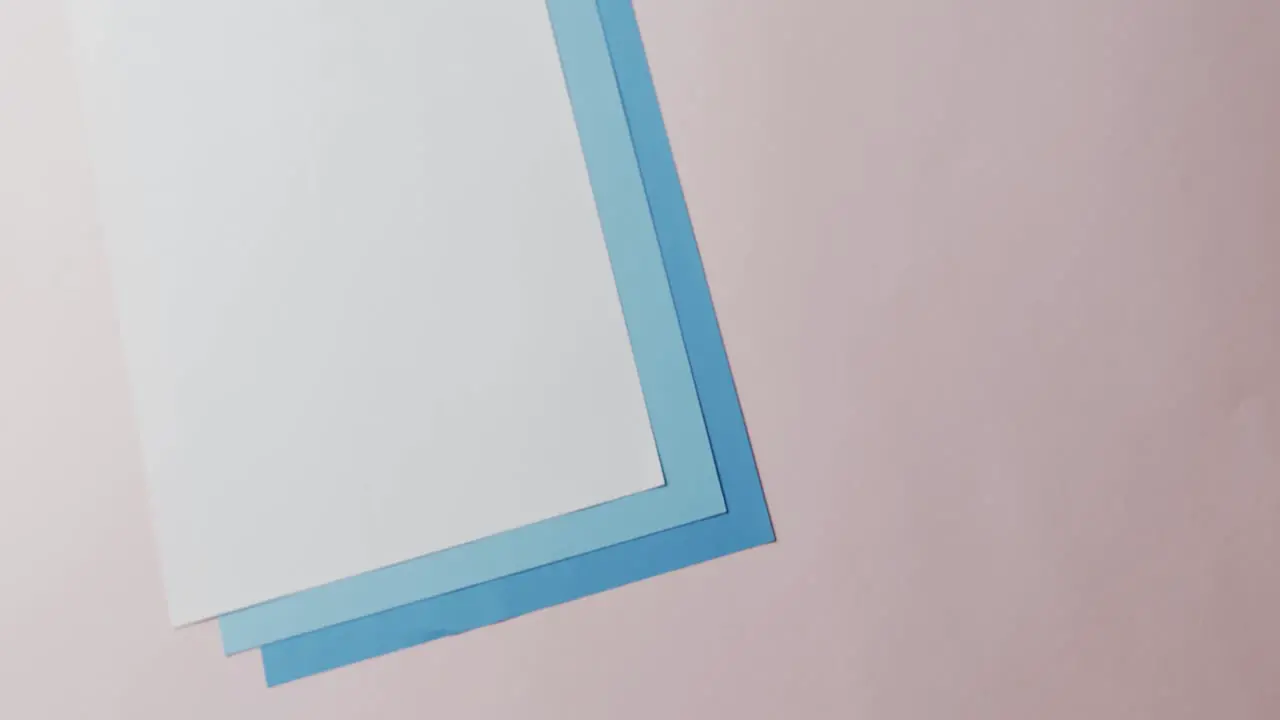 Close up of blank and blue cards on white background with copy space in slow motion