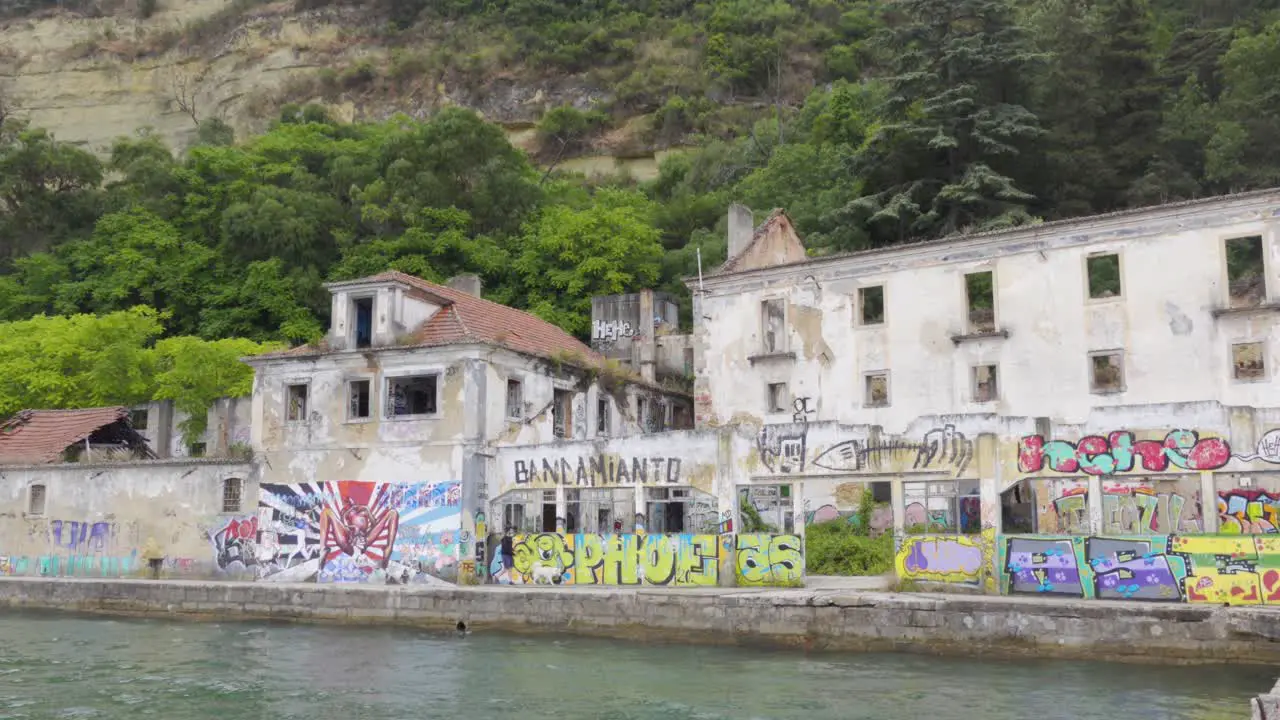 Abandoned Industrial Ruins with lots of Graffiti on the other side of the river in Lisbon Almada Portugal