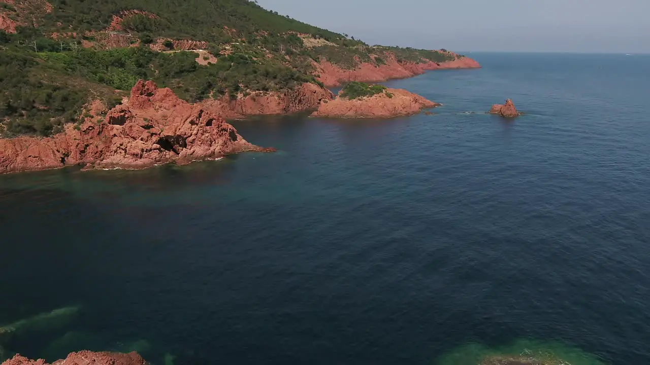 Aerial orbit over Antibes red rocks landscape by the sea