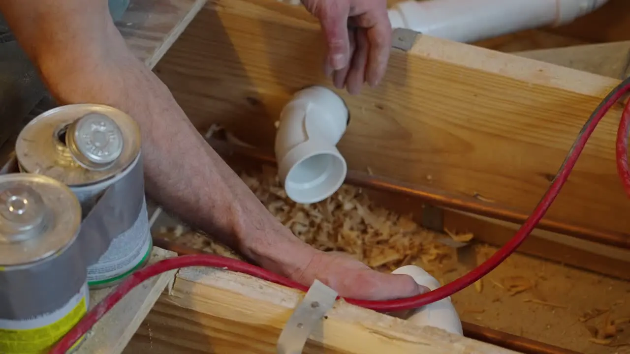 Plumber laying out drain lines for installation