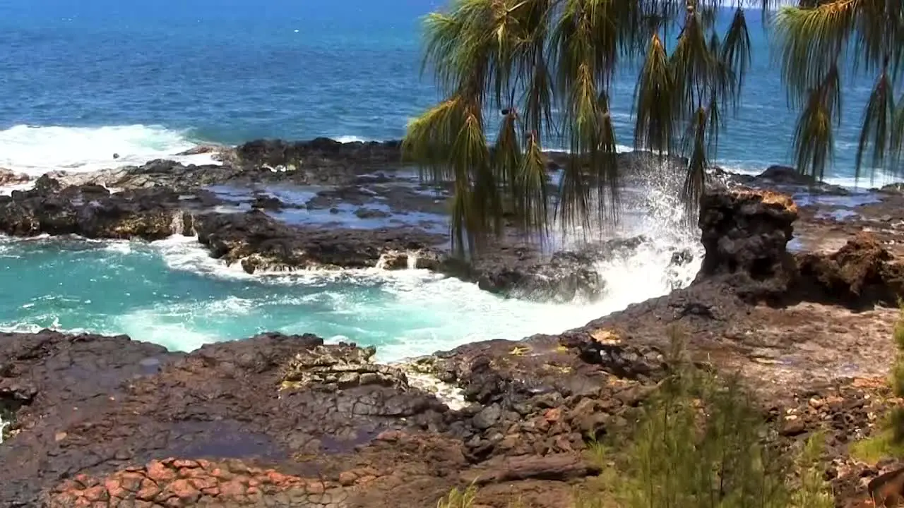 Waves gently crashing onto the Hawaiian shoreline